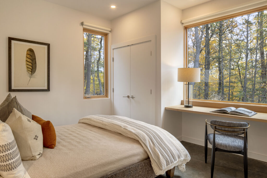 Cozy modern bedroom at Fermata, a custom home