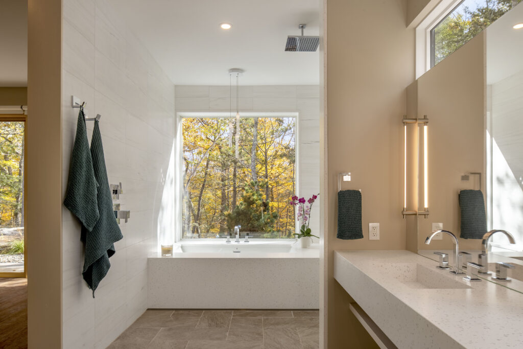 The main bathroom at Fermata has a custom floating countersink and a built-in countertop clad tub.