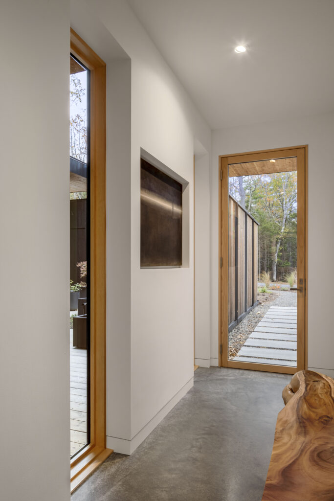 Fermata features a modern entry with warm wood windows.