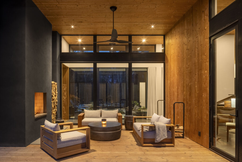 Fermata includes a cozy outdoor fireplace nook that is lined with warm wood and looks towards the interior courtyard.