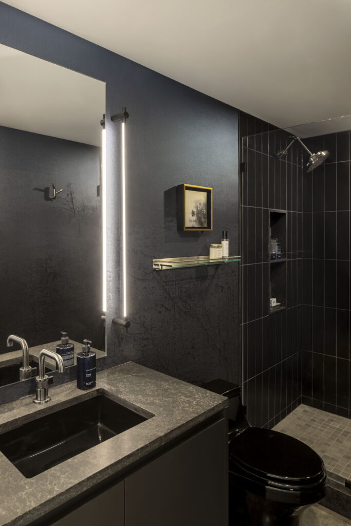 Fermata includes a black bathroom with feature wallpaper and steel fixtures.